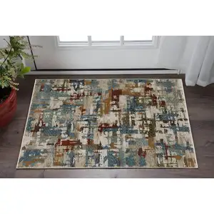 Photo of Beige Teal And Brown Abstract Area Rug With Fringe