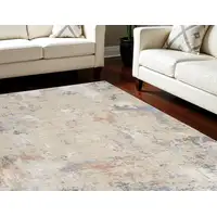 Photo of Beige Teal Blue and Gray Abstract Area Rug With Fringe