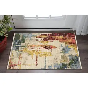 Photo of Beige Yellow And Orange Abstract Area Rug With Fringe