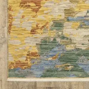 Photo of Beige Yellow And Rust Abstract Area Rug With Fringe