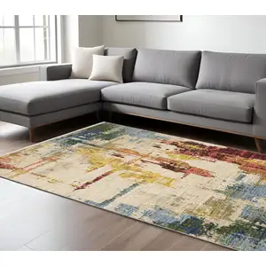 Photo of Beige Yellow And Rust Abstract Area Rug With Fringe