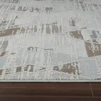 Photo of Beige and Brown Abstract Distressed Area Rug