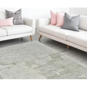 Photo of Beige and Green Abstract Distressed Area Rug