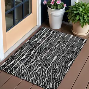 Photo of Black And Ivory Abstract Washable Indoor Outdoor Area Rug