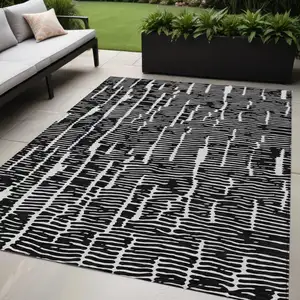 Photo of Black And Ivory Abstract Washable Indoor Outdoor Area Rug