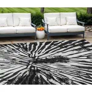 Photo of Black Charcoal And Ivory Abstract Washable Indoor Outdoor Area Rug