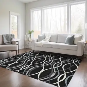 Photo of Black Gray And Ivory Abstract Washable Indoor Outdoor Area Rug