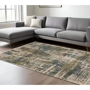 Photo of Blue And Gold Abstract Distressed Area Rug With Fringe