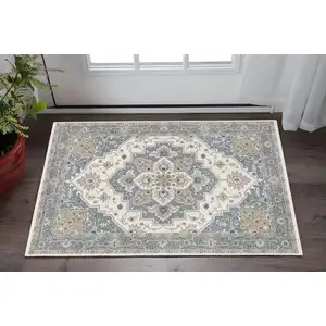 Photo of Blue And Ivory Medallion Distressed Area Rug With Fringe