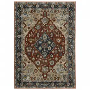 Photo of Blue Beige Tan Brown Gold And Rust Red Oriental Power Loom Stain Resistant Area Rug With Fringe