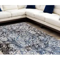 Photo of Blue Black and Ivory Abstract Power Loom Distressed Area Rug