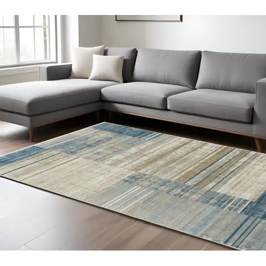 6' X 9' Blue Dark Blue Teal Grey Ivory Beige And Tan Geometric Power Loom Stain Resistant Area Rug With Fringe Photo 1