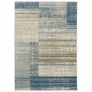 Photo of Blue Dark Blue Teal Grey Ivory Beige And Tan Geometric Power Loom Stain Resistant Area Rug With Fringe