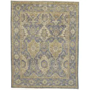 Photo of Blue Gold And Tan Wool Floral Hand Knotted Stain Resistant Area Rug With Fringe