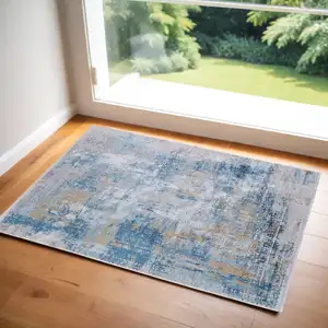 Photo of Blue Gold and Gray Abstract Power Loom Area Rug With Fringe