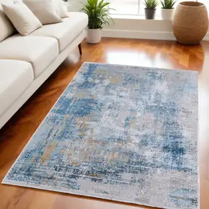 Photo of Blue Gold and Gray Abstract Power Loom Area Rug With Fringe