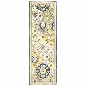 Photo of Blue Green Gold Navy And Ivory Geometric Tufted Handmade Stain Resistant Runner Rug