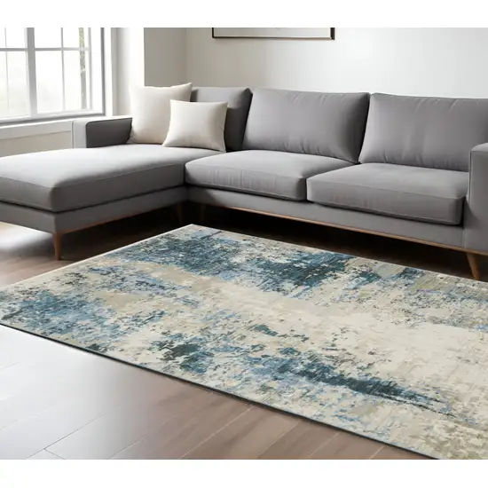 6' X 9' Blue Grey Ivory Light Blue And Dark Blue Abstract Power Loom Stain Resistant Area Rug With Fringe Photo 1