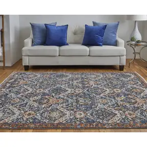 Photo of Blue Orange And Ivory Floral Power Loom Area Rug With Fringe