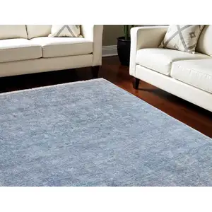 Photo of Blue and Gray Abstract Hand Woven Distressed Area Rug With Fringe