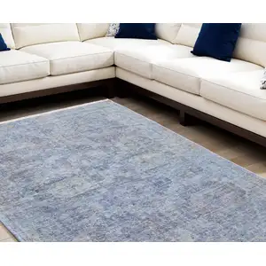 Photo of Blue and Ivory Abstract Hand Woven Distressed Area Rug With Fringe