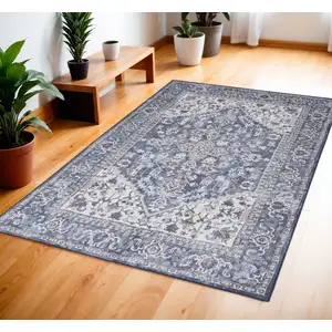 Photo of Blue and Ivory Floral Medallion Power Loom Distressed Area Rug