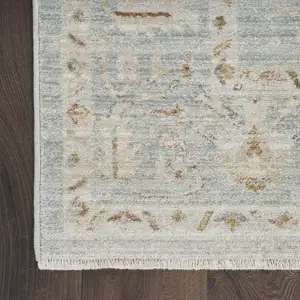 Photo of Blue and Ivory Oriental Power Loom Distressed Area Rug With Fringe