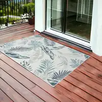 Photo of Blue and Serene White Palm Leaf Stain Resistant Indoor Outdoor Area Rug