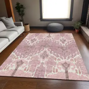 Photo of Blush Pink And Ivory Ikat Washable Indoor Outdoor Area Rug