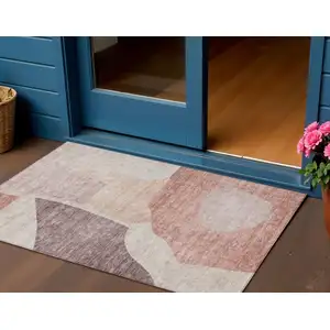 Photo of Blush Pink And Mauve Abstract Washable Indoor Outdoor Area Rug