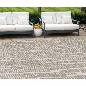 Photo of Brown And Ivory Abstract Washable Indoor Outdoor Area Rug