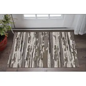 Photo of Brown and Ivory Abstract Power Loom Distressed Area Rug