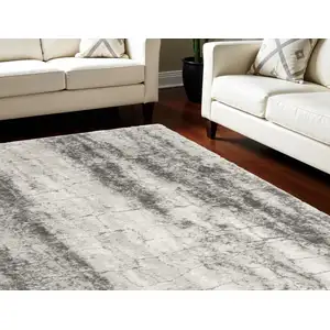 Photo of Charcoal And Ivory Abstract Shag Distressed Area Rug