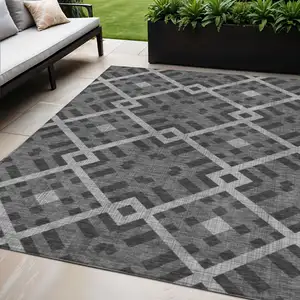 Photo of Charcoal Gray And Silver Geometric Washable Indoor Outdoor Area Rug