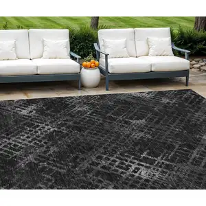 Photo of Charcoal Gray And Silver Geometric Washable Indoor Outdoor Area Rug