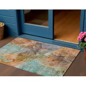 Photo of Copper Orange And Teal Blue Abstract Washable Indoor Outdoor Area Rug