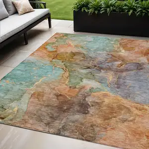 Photo of Copper Orange And Teal Blue Abstract Washable Indoor Outdoor Area Rug