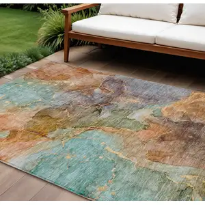 Photo of Copper Orange And Teal Blue Abstract Washable Indoor Outdoor Area Rug