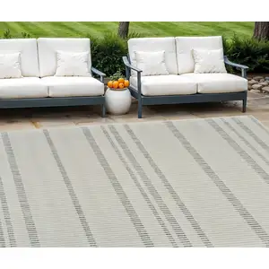 Photo of Cream and Beige Striped Distressed Indoor Outdoor Area Rug