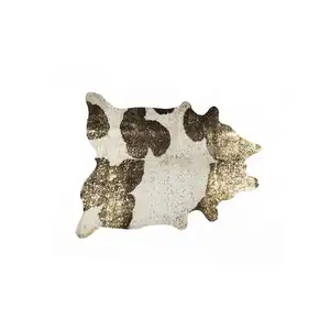 Photo of Dark Brown White and Gold Natural Cowhide Area Rug