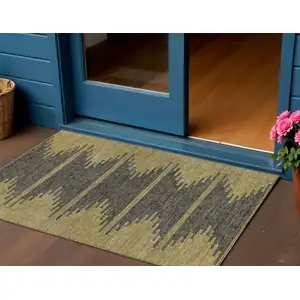 Photo of Dark Gray And Gold Abstract Washable Indoor Outdoor Area Rug