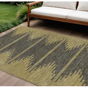 Photo of Dark Gray And Gold Abstract Washable Indoor Outdoor Area Rug