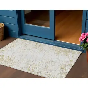 Photo of Gold And Ivory Abstract Washable Indoor Outdoor Area Rug