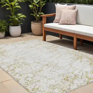 Photo of Gold And Ivory Abstract Washable Indoor Outdoor Area Rug