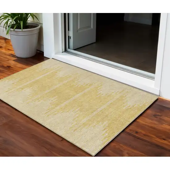 Gold And Ivory Abstract Washable Indoor Outdoor Area Rug Photo 1