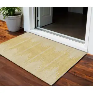 Photo of Gold And Ivory Abstract Washable Indoor Outdoor Area Rug