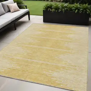 Photo of Gold And Ivory Abstract Washable Indoor Outdoor Area Rug