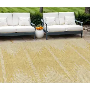 Photo of Gold And Ivory Abstract Washable Indoor Outdoor Area Rug