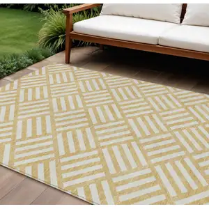 Photo of Gold And Ivory Geometric Washable Indoor Outdoor Area Rug