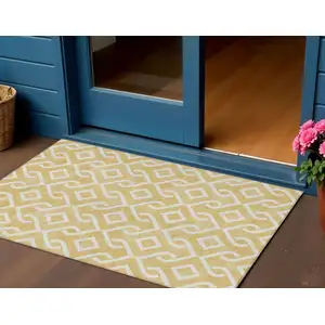 Photo of Gold And Ivory Geometric Washable Indoor Outdoor Area Rug